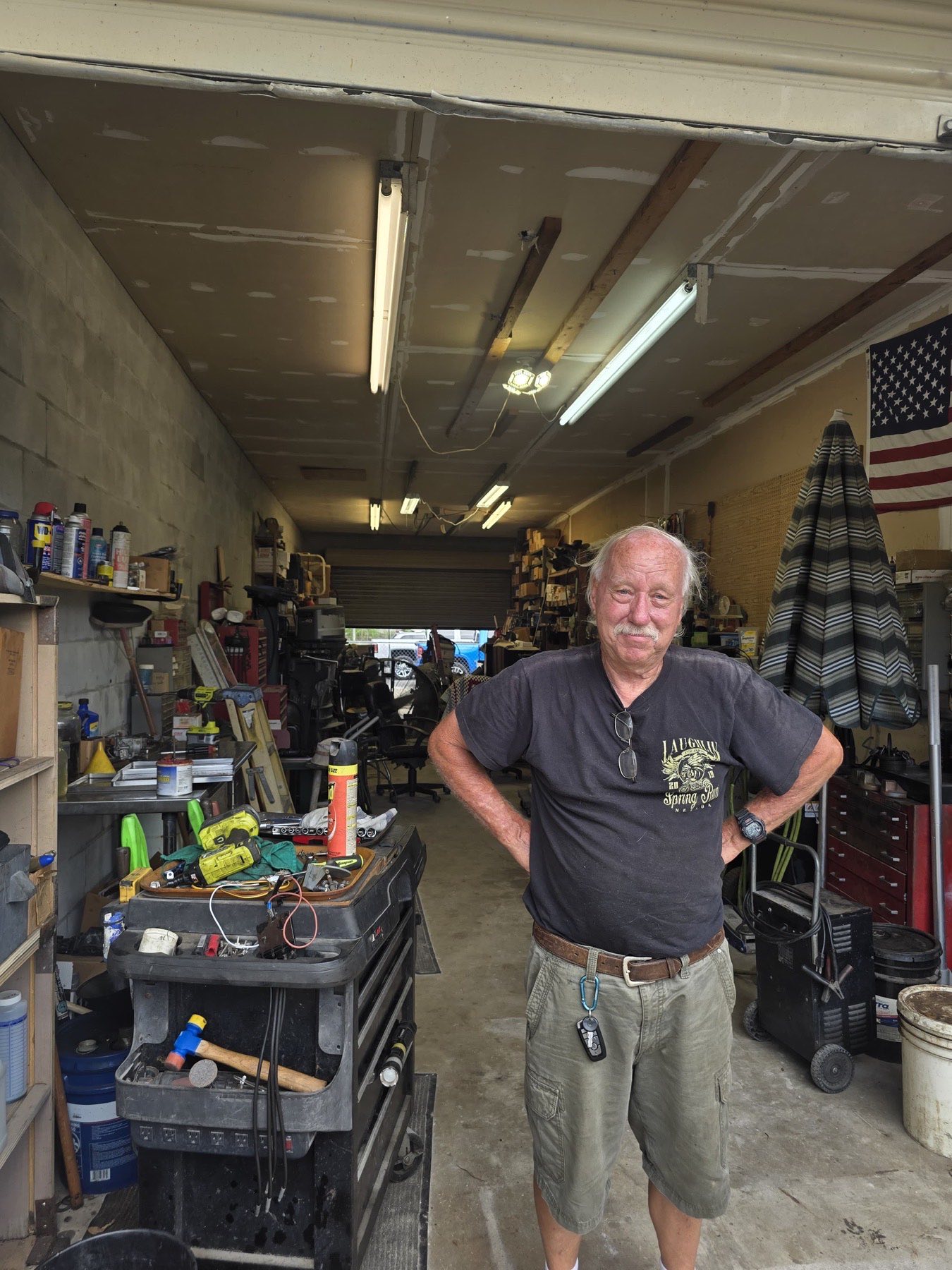 Ed, owner of DeBary Outboard Repair, standing in his shop